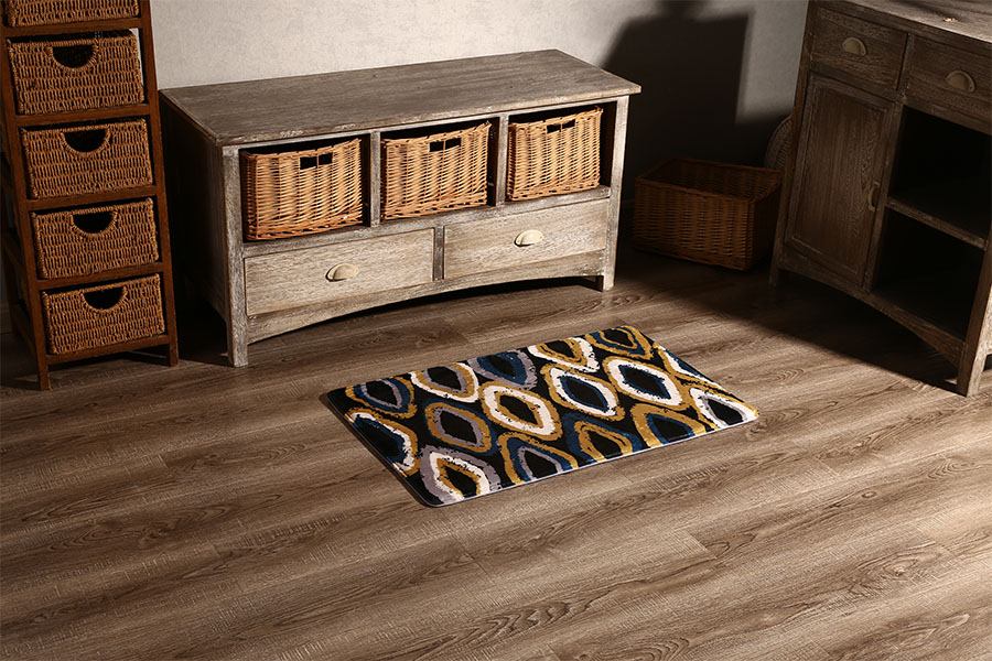 Patterned absorbent floor mat