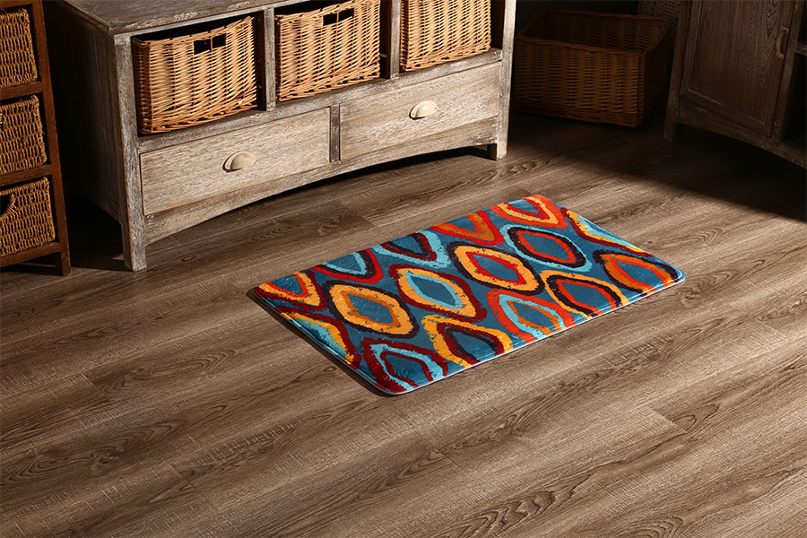 Patterned absorbent floor mat