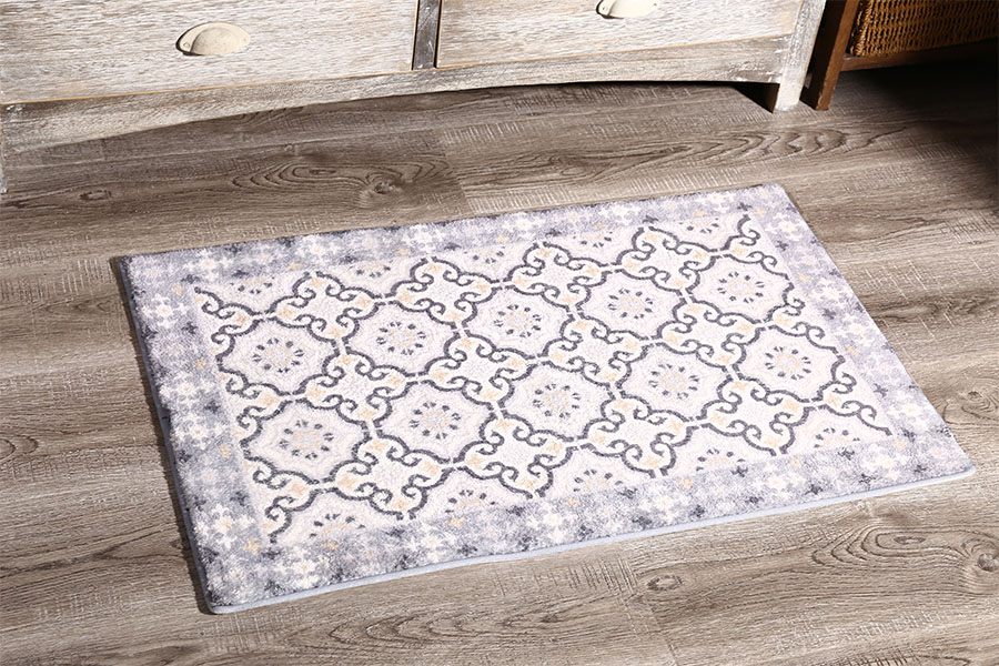 Patterned absorbent floor mat